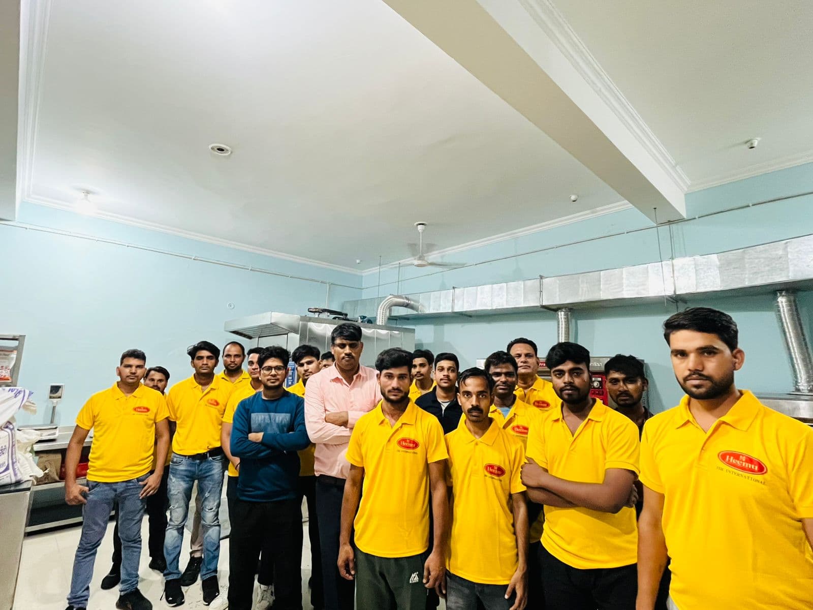 JBR bakery team gathered in the kitchen with production equipment in the background