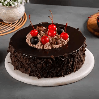 Black Forest cake with dark chocolate shavings and fresh cherries