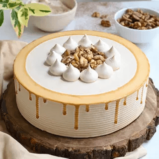 Caramel-drizzled cake topped with meringue kisses and walnuts