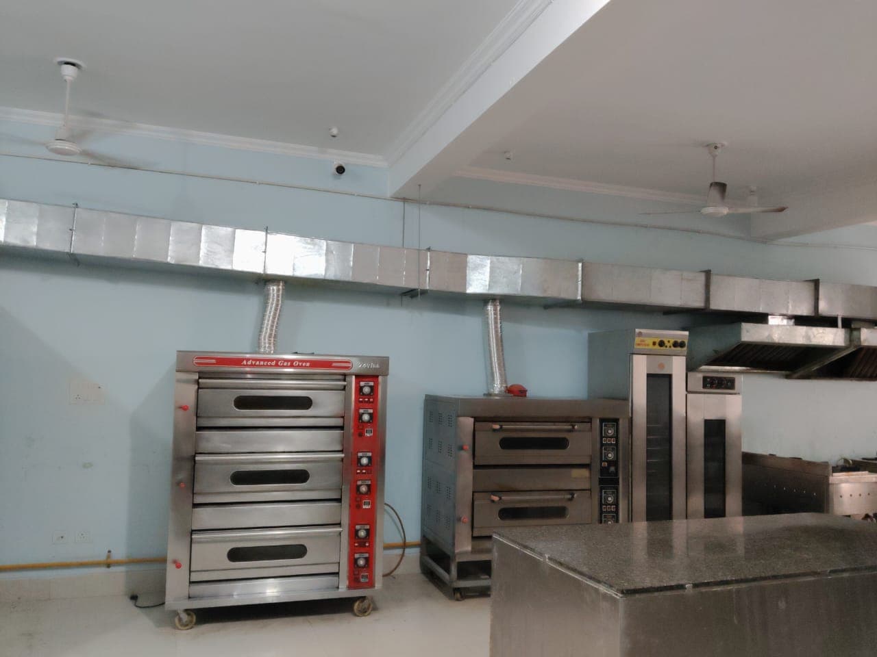 Production area with industrial mixers and ovens